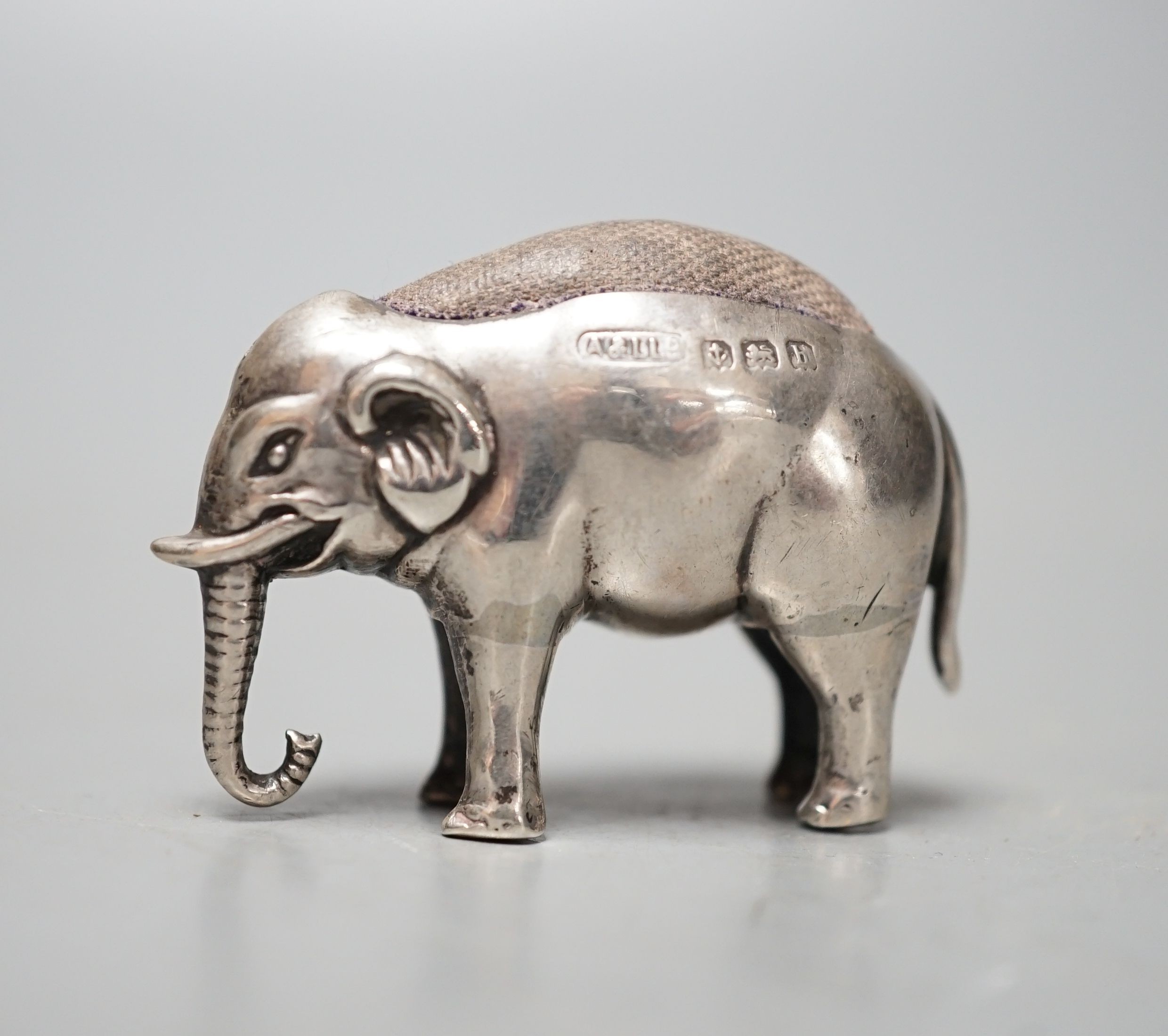An Edwardian novelty silver elephant pin cushion, Adie & Lovekin Ltd, Birmingham, 1907, length 4cm.